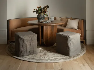 A cozy, curved seating arrangement with a wooden table in a dining room setting.
