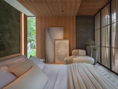 A modern bedroom with white bedding, wooden walls, and marble accent.