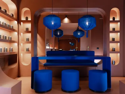 A modern restaurant interior with a blue countertop, wooden accents, and soft lighting creating a relaxing atmosphere