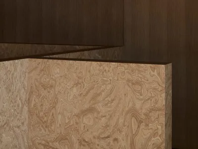 A cozy room with a wooden wall, brown wood finish, and steps leading up to a higher level, creating a warm and inviting atmosphere
