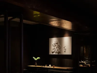 Cozy Asian restaurant interior with a wooden table, chairs, and a potted plant, creating a welcoming atmosphere