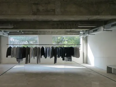 空曠空間內的玻璃展示櫃，陳列各種尺寸與款式的夾克，營造乾淨整潔的氛圍