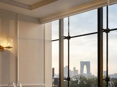 Dining area with glass window, city skyline view, fine dining elements, and comfortable seating for guests