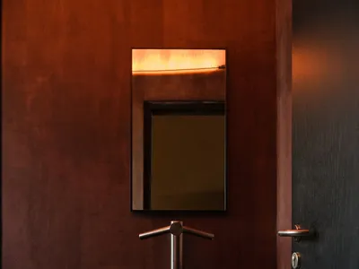 Bathroom with a black sink, brown walls, and dim lighting