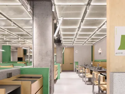 Modern restaurant interior with a green wall, white ceiling, and multiple dining tables and chairs