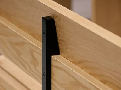 A modern wooden bed with a black metal headboard, featuring a sleek and minimalist design with high-quality wood and a warm inviting feel