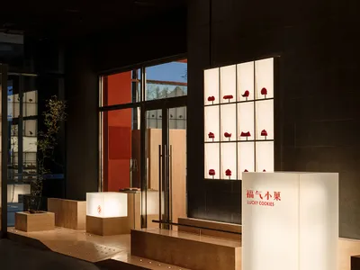 A warm and inviting showroom with red lanterns on a wall, wooden benches, and a cozy atmosphere