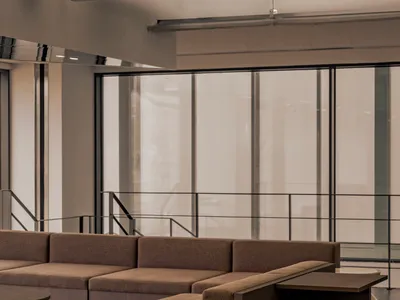 A spacious room with several couches in various positions, creating a calm and inviting atmosphere for relaxation and socializing