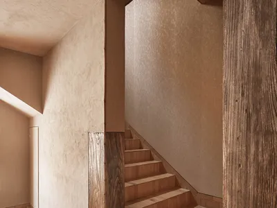A warm and inviting wooden staircase with brown treads and risers, set against a neutral background