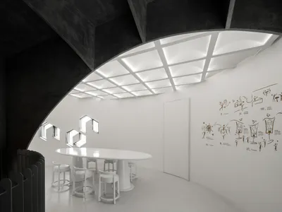 Empty white room with a curved wall, chairs, and a dining table, creating a clean and minimalistic atmosphere