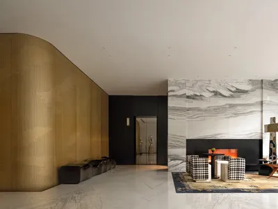 Sophisticated living space with a checkered rug, black and gold walls, two couches, chairs, and a fireplace