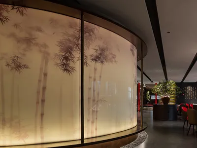 A restaurant interior with wooden furniture, oriental artwork, and a bar area, creating a warm and inviting atmosphere