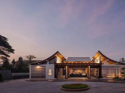 Spacious Asian-style restaurant with wooden structure, potted plants, and a warm atmosphere