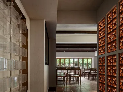 Inviting restaurant space with a tiled floor, chairs, and a dining table, perfect for socializing and enjoying a meal
