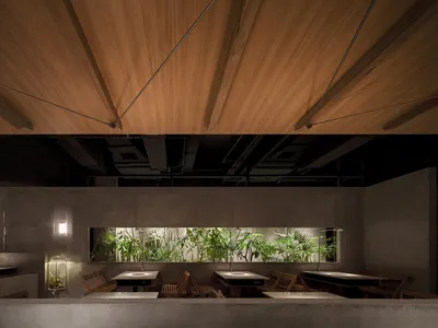 Warm and inviting dining area with wooden tables and chairs, potted plants, and multiple seating options