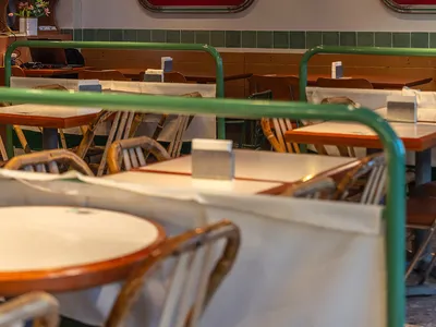 Warm and inviting Asian restaurant with wooden tables, red signs, and cozy lighting
