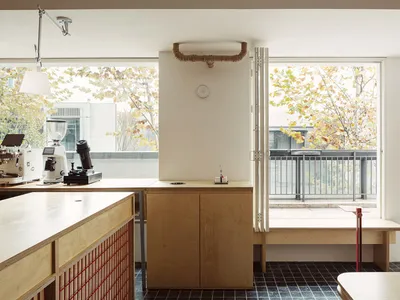 Warm and inviting kitchen space with wooden cabinets, a dining table, and natural light from a window