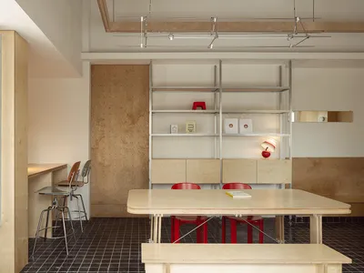 Open dining area with a wooden table and red chairs, suggesting a cozy and inviting atmosphere for gatherings and meals