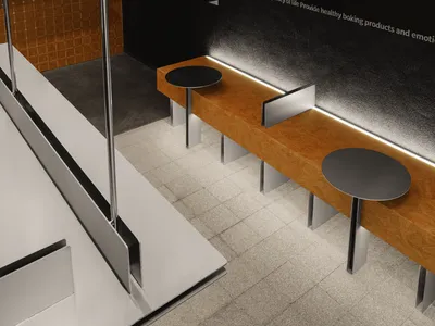 A restaurant dining area with tables, chairs, a couch, and writings on the walls, set in a well-lit space