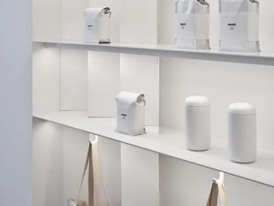 A well-organized shelf in a store filled with various bags of coffee, creating a cozy and inviting atmosphere for customers