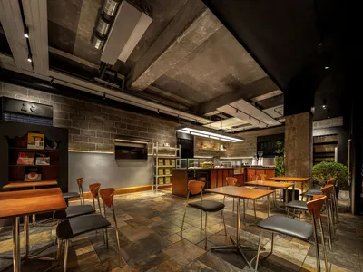 Cozy dining area with multiple seating options, dimly lit with warm ambiance, featuring wood, metal, and glass elements