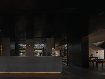 Professional hotel lobby with a reception desk, counter, and guests, featuring a welcoming atmosphere