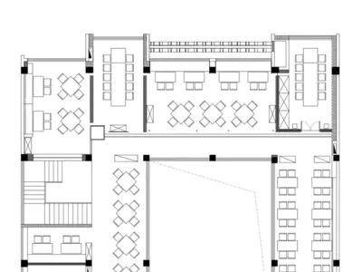 2D floor plan of an empty restaurant interior with multiple seating areas and tables, clean and organized layout