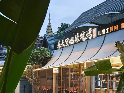 A modern Asian restaurant patio with tables, chairs, umbrellas, and potted plants, featuring a warm atmosphere with orange and white colors and natural and artificial lighting