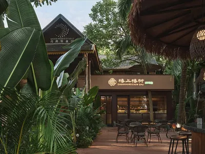 Modern Asian restaurant with a patio area featuring several chairs and dining tables, well-lit for a welcoming atmosphere