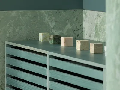 A clean bathroom with a countertop featuring decorative blocks and bottles, showcasing a focus on functionality and aesthetics