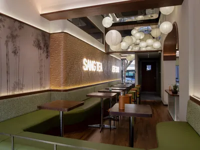 Cozy Asian restaurant interior with wooden floors, bamboo walls, and dim lighting