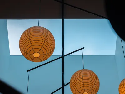 A warm and inviting interior space with five paper lantern-style ceiling lights providing soft illumination