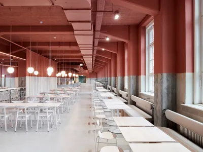 Modern dining area with white tables and chairs, well-lit and inviting