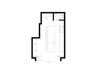 A calm and welcoming hotel lobby with a few chairs and a clean, minimalist design