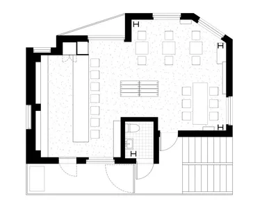 Black and white floor plan of a hotel with various rooms and spaces, including a lobby and dining area