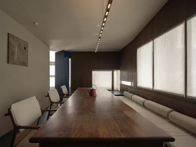 A well-lit dining area with a wooden table and chairs, creating a warm and elegant atmosphere