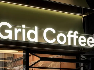 A casual coffee shop interior with a counter, seating areas, and various cups and bottles on display