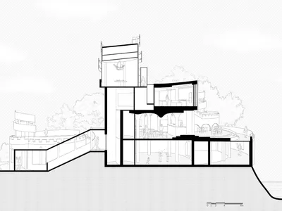 A modern hotel with multiple levels, a rooftop area, and clean lines, featuring people and trees in the background