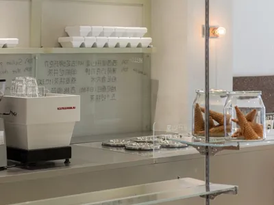 A casual restaurant counter with displayed food, cups, and bottles, set in a welcoming atmosphere