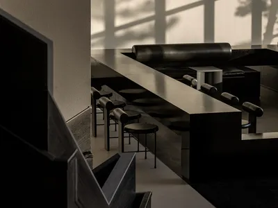 Empty modern restaurant with black tables and chairs arranged in rows, minimalist decoration, and a focus on functionality