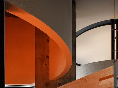 Warm and inviting room with orange lighting, a circular wall design, and a dining table and two chairs