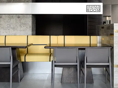 Dining area with multiple tables and chairs in a well-lit restaurant with modern decor