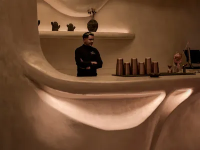 Warm and inviting restaurant interior with a bar area, vases, and comfortable atmosphere