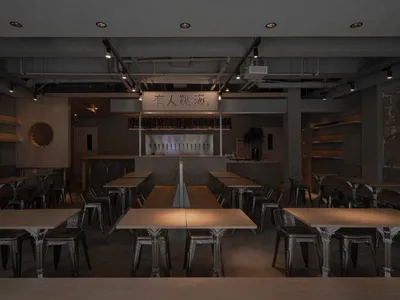 Dimly lit restaurant with metal tables and chairs, creating a cozy atmosphere