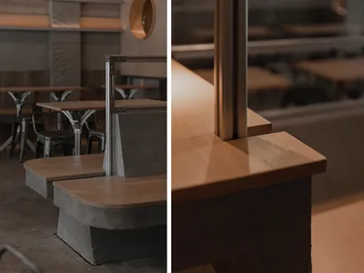 A well-lit restaurant interior with wooden countertops, dining tables, and comfortable seating, perfect for socializing and enjoying meals