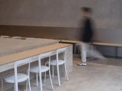 A casual restaurant dining area with multiple chairs and small tables arranged throughout the space, creating a comfortable atmosphere for patrons