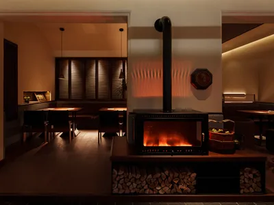 Cozy restaurant dining area with a wood stove, multiple chairs, and dining tables near the fireplace