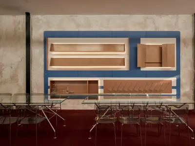 Modern dining area with a glass table surrounded by chairs in a contemporary and stylish environment