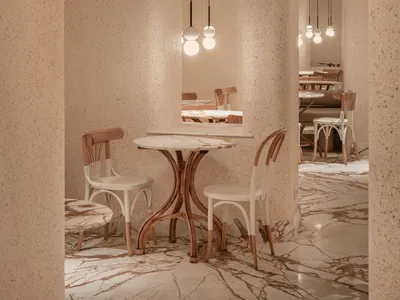 Empty restaurant interior with white tables, chairs, and lamps, creating a calm and inviting atmosphere