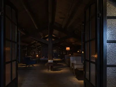 Cozy open concept living space with a large wooden beam, seating areas, a dining table, and dim lighting